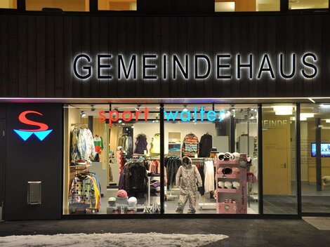 Ein Geschäft mit Sportkleidung und Accessoires ist zu sehen. Die Beleuchtung sorgt für eine einladende Atmosphäre.